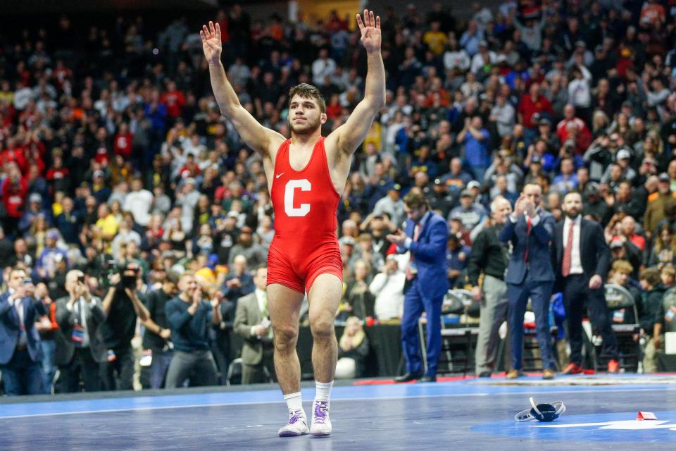 Cornell's Yianni Diakomihalis holds up four fingers after defeating Ohio State's Sammy Sasso to claim his fourth national championship, at the NCAA Division I wrestling championships Saturday, March 18, 2023, in Tulsa, Okla. (Ian Maule/Tulsa World via AP)