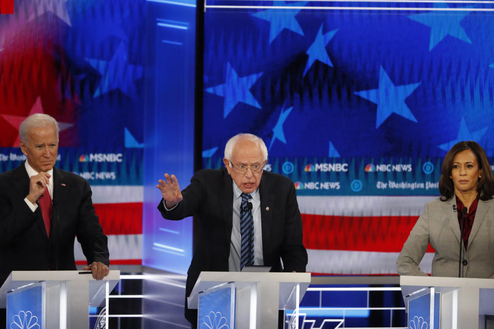 Democratic presidential candidate Sen. Bernie Sanders, I-Vt., speaks as former Vice President Joe Biden and Sen. Kamala Harris, D-Calif., listen during a Democratic presidential primary debate, Wednesday, Nov. 20, 2019, in Atlanta. (AP Photo/John Bazemore)