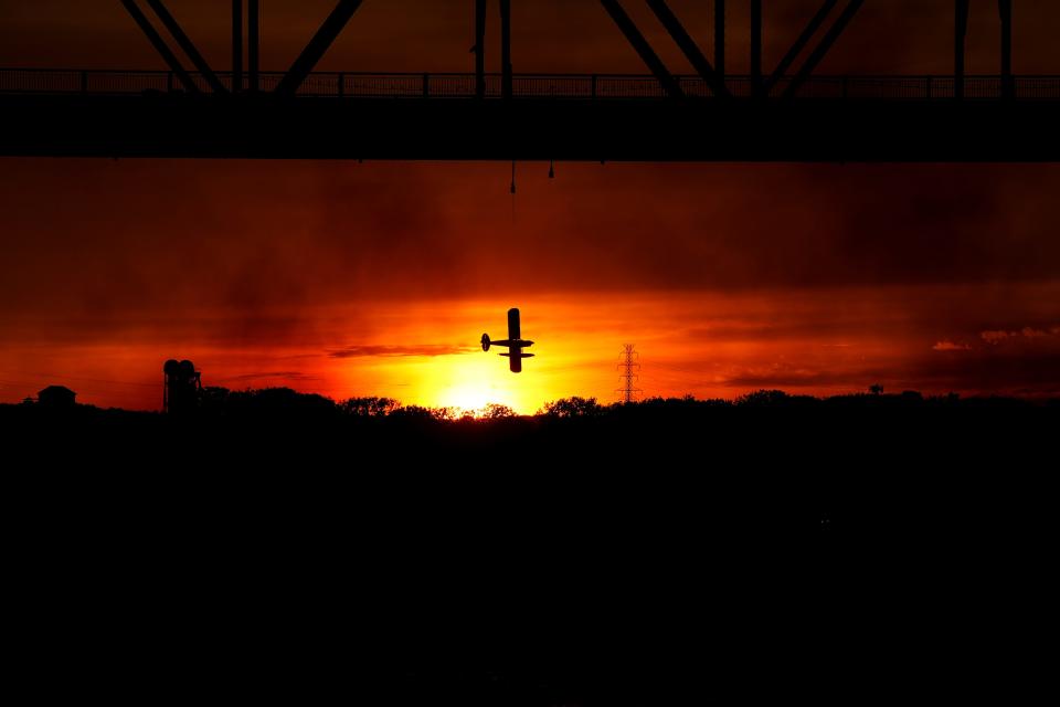 The Jeff Gordon Carbon Cub Float Plane flies across the sunset during the Thunder Over Louisville airshow on Saturday, April 20, 2024.