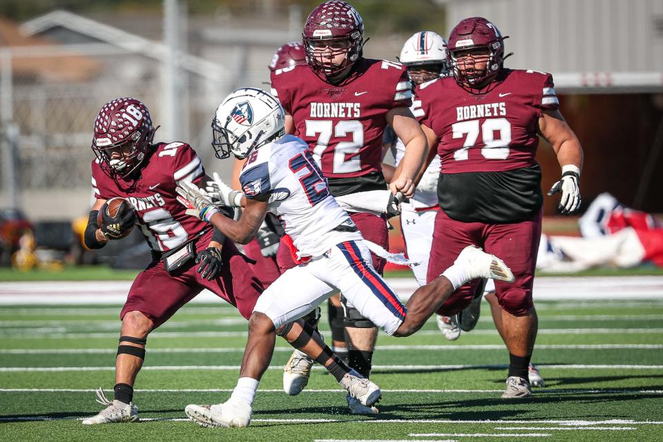 Flour Bluff's Jayden Johnson is tackled by San Antonio Veterans Memorial's Ja'Kwon Downing during the Class 5A Division II regional round on Nov. 26, 2022, in Corpus Christi, Texas.