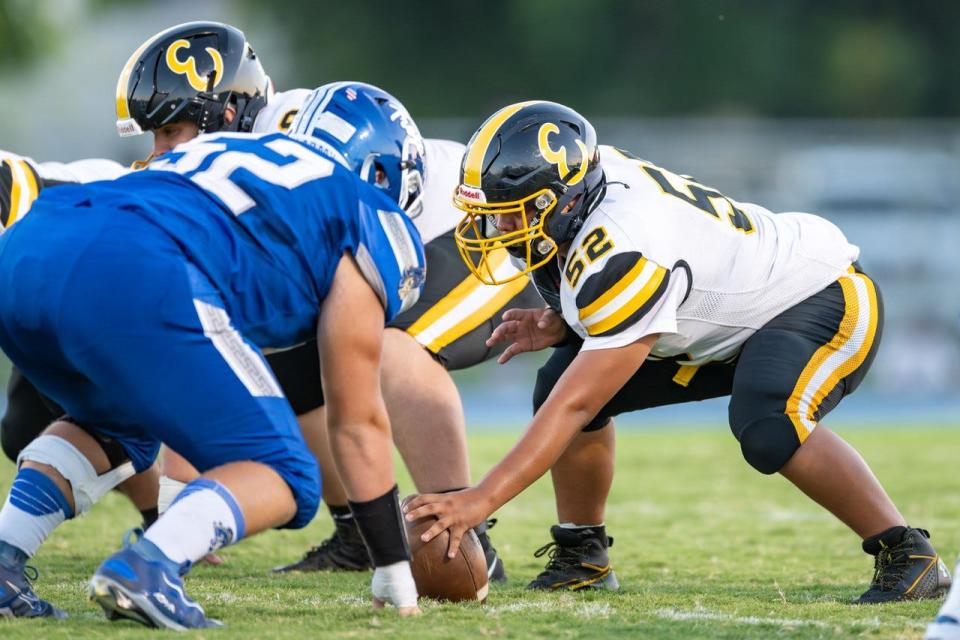Enterprise junior center Jose Rincon (right) prepares to snap the ball against Orland senior Jeremy Robbins (left) on Friday, Aug. 25, 2023.