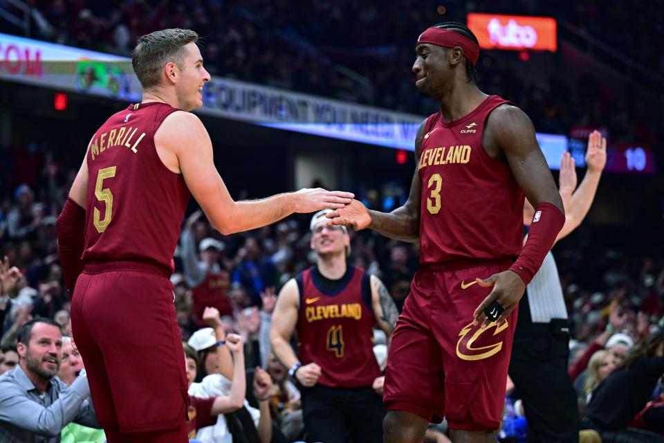 Cleveland Cavaliers guard Sam Merrill, left, is congratulated by guard Caris LeVert after a 3-point basket against the Utah Jazz during the first half of an NBA basketball game Wednesday, Dec. 20, 2023, in Cleveland. (AP Photo/David Dermer)