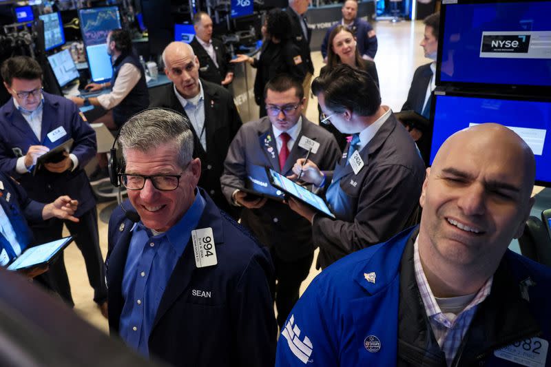 Traders work on the floor of the NYSE in New York