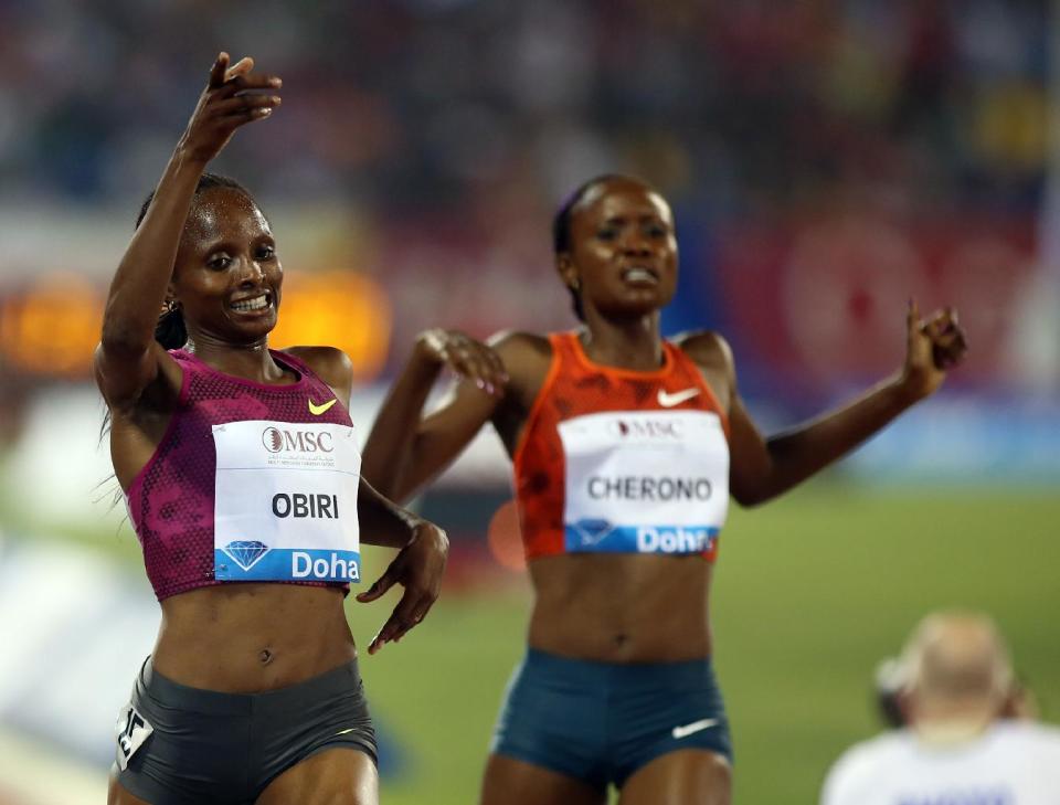 Hellen Obiri of Kenya, left, celebrates winning the women's 3000m at the IAAF Diamond League in the Qatari capital Doha, Friday May 9, 2014. (AP Photo/Osama Faisal)