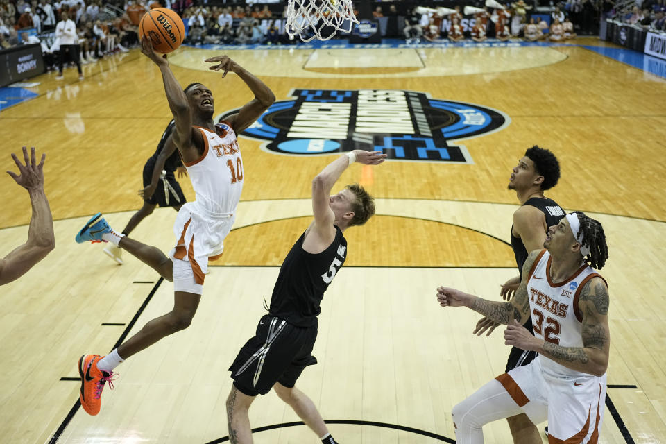 Texas guard Sir'Jabari Rice shoots over Xavier guard Adam Kunkel in the second half of a Sweet 16 college basketball game in the Midwest Regional of the NCAA Tournament Friday, March 24, 2023, in Kansas City, Mo. (AP Photo/Jeff Roberson)