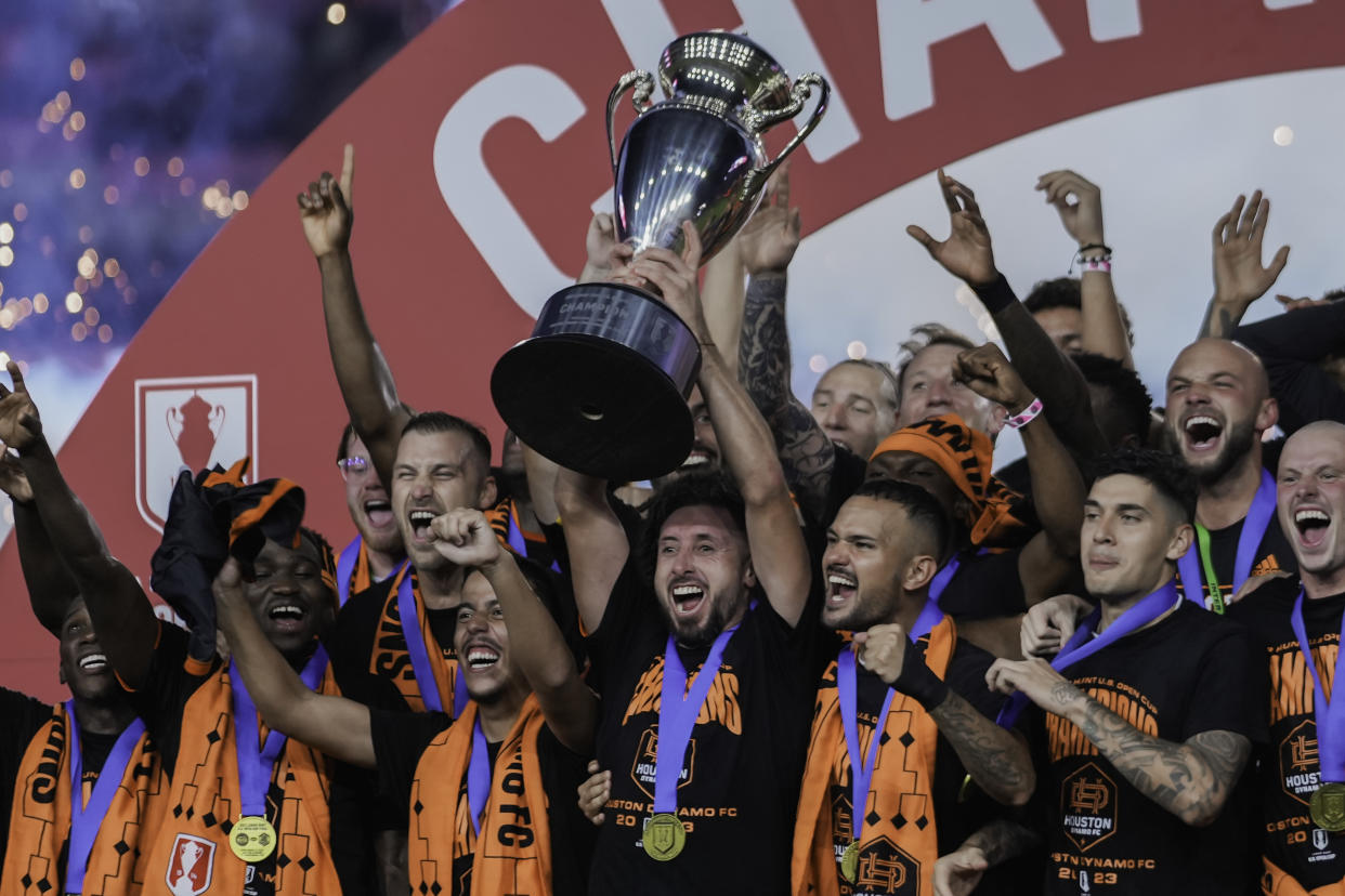 FORT LAUDERDALE, FL - SEPTEMBER 27: Hector Herrera #16 of the Houston Dynamo FC raises the trophy on the podium with the rest of his team during a game between Houston Dynamo FC and Inter Miami CF at DRV PNK Stadium on September 27, 2023 in Fort Lauderdale, Florida. (Photo by Jason Allen/ISI Photos/Getty Images)
