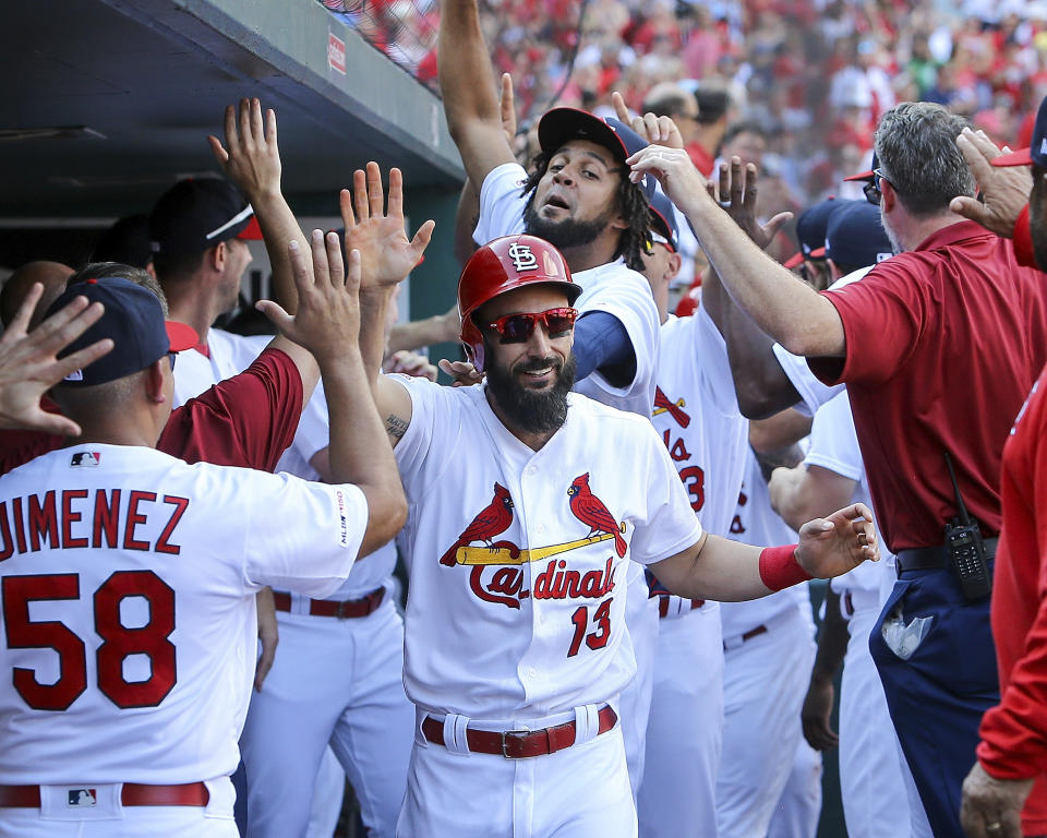 St. Louis Cardinals' Matt Carpenter, center, is congratulated by teammates after hitting a three-run home run during the third inning of a baseball game against the Chicago Cubs Sunday, Sept. 29, 2019, in St. Louis. (AP Photo/Scott Kane)