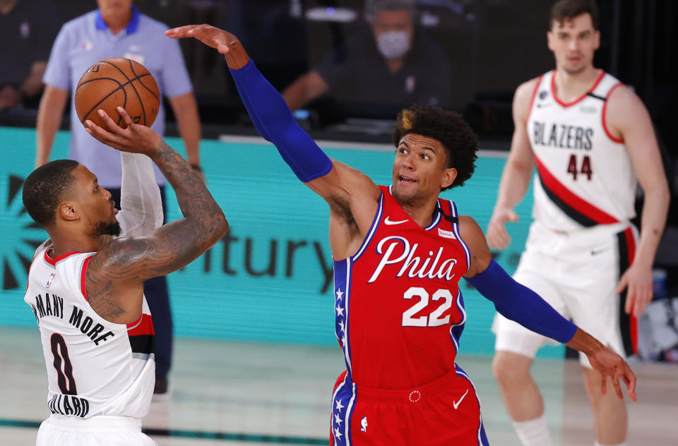 Philadelphia 76ers' Matisse Thybulle (22) defends against Portland Trail Blazers' Damian Lillard during the third quarter of an NBA basketball game Sunday, Aug. 9, 2020, in Lake Buena Vista, Fla. (Kevin C. Cox/Pool Photo via AP)