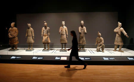 A member of the museum staff walks past a display of Terracotta Warriors which guarded the tomb of China’s First Emperor, Qin Shi Huang, on loan from China in The World Museum, Liverpool, Britain February 6, 2017.REUTERS/Andrew Yates