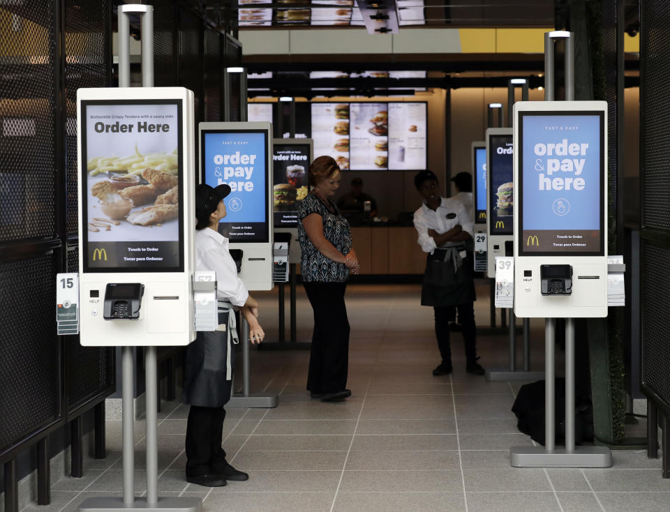 FILE - This Aug. 8, 2018, file photo shows electronic menus at the McDonald's flagship restaurant in Chicago. In a very limited test in Canada, McDonald's said Thursday, Sept. 26, 2019, that it's introducing the PLT, or the plant, lettuce and tomato burger. It will be available for 12 weeks in 28 restaurants in Southwestern Ontario by the end of the month. (AP Photo/Nam Y. Huh, File)