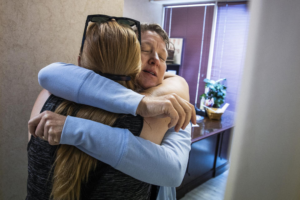 Image: Dr. Cheryl Hamlin hugs Kim Gibson, co-founder of The Pink House Defenders and clinic escort, before heading back home to Massachusetts at the Jackson Women's Health Organization clinic  in Jackson, Miss., on June 7, 2022. (Erin Clark / Boston Globe via Getty Images file)