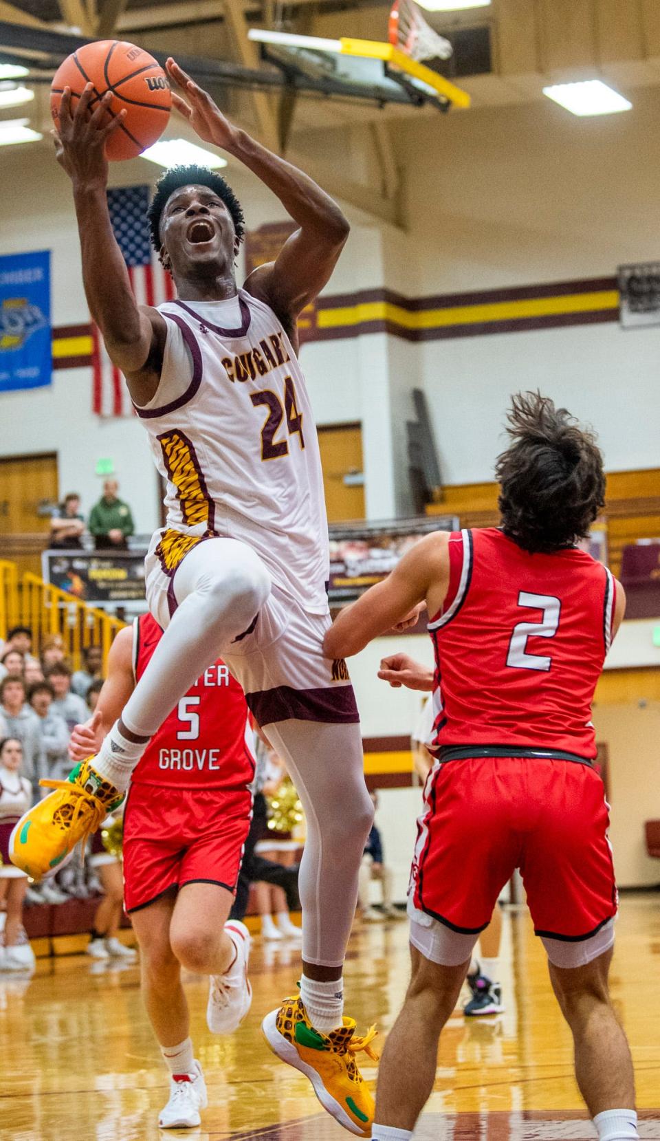 Bloomington North's JaQualon Roberts (24) shoots past Center Grove's Owen Baker (2) during the Bloomington North versus Center Grove boys basketball game at Bloomington High School North on Friday, Dec. 2, 2022.