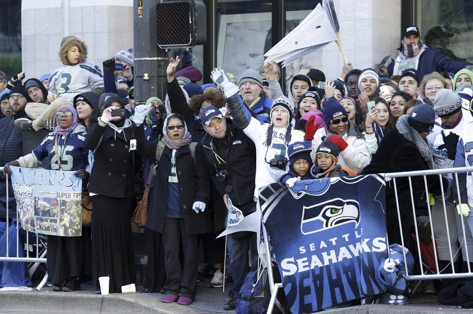 Seattle Seahawks fans cheer along the route of the Super Bowl champions parade on Wednesday, Feb. 5, 2014, in Seattle. The Seahawks beat the Denver Broncos 43-8 in NFL football's Super Bowl XLVIII on Sunday. (AP Photo/Ted S. Warren)