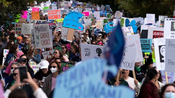 PHOTO: Demonstrators hold signs as they rally during the Women's March in Washington,  Oct. 8, 2022. (Jose Luis Magana/AP)