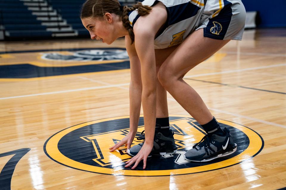 For good luck and respect Clawson High School's Addison Tikey touches the initials of Alex Verner before she heads out to face Ferndale's University High School on Monday Feb. 5, 2024. Alex Verner was killed by a gunman a year ago while she was attending Michigan State University. Verner's name and jersey number are painted on the court. As a new tradition, the team starters tap the AV 24 before entering the game.