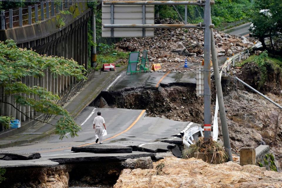 A damaged road in Kumamura (AP)