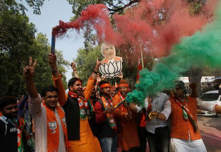 Supporters of Bharatiya Janata Party (BJP) celebrate after learning of the initial poll results outside the party headquarters in New Delhi, March 11, 2017. REUTERS/Adnan Abidi