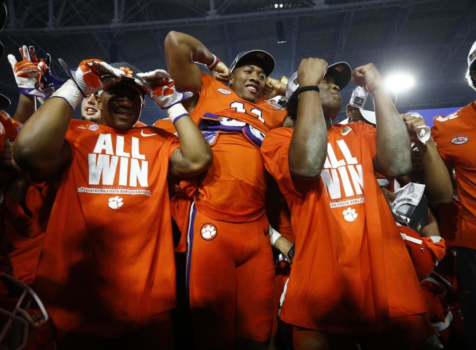 Clemson players celebrate after Clemson defeated Ohio State 31-0 in the Fiesta Bowl NCAA college football playoff semifinal, Saturday, Dec. 31, 2016, in Glendale, Ariz. Clemson advanced to the BCS championship game Jan. 9 against Alabama. (AP Photo/Ross D. Franklin)