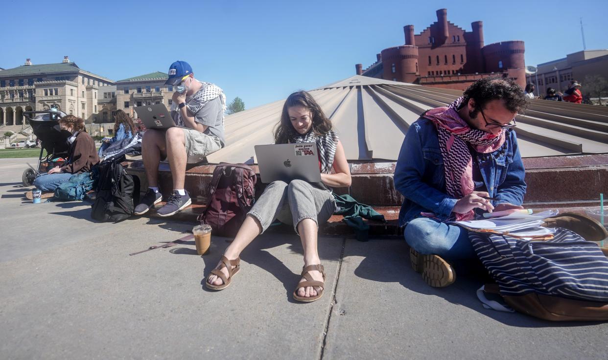 Maya Banks, a graduate teaching assistant, and Alex Dressler, a professor, sit on Library Mall to support the UW-Madison students’ solidarity against the Israel-Hamas war.