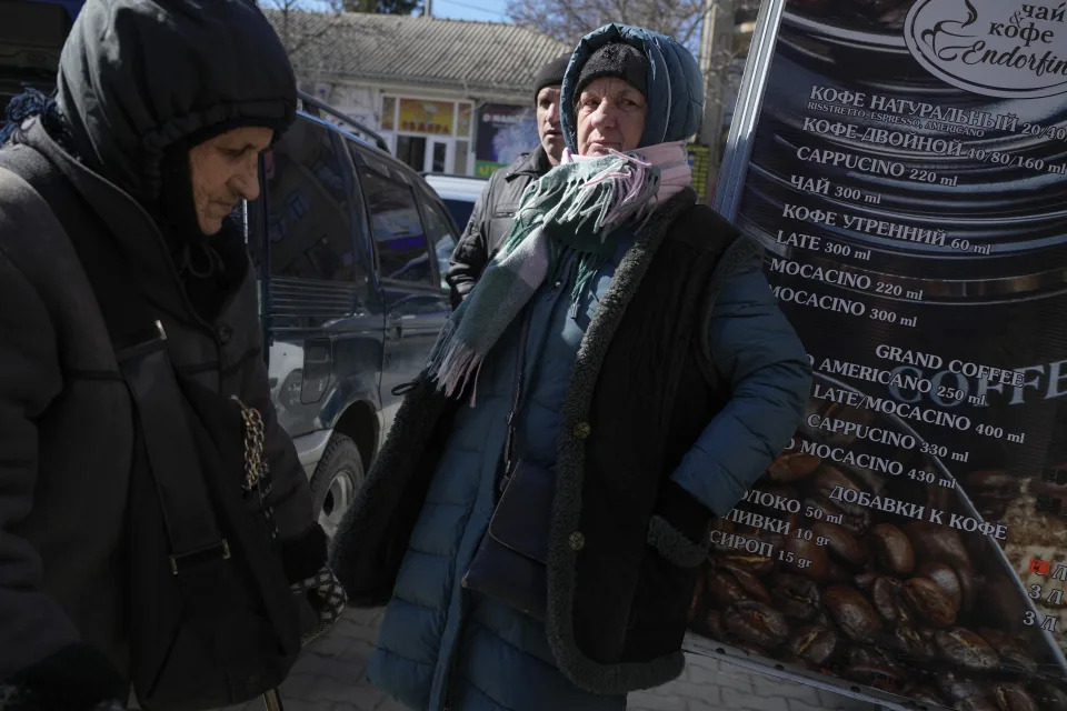 People mingle at a street market in Comrat, Moldova, Saturday, March 12, 2022. Across the border from war-engulfed Ukraine, tiny, impoverished Moldova, an ex-Soviet republic now looking eagerly Westward, has watched with trepidation as the Russian invasion unfolds. In Gagauzia, a small, autonomous part of the country that's traditionally felt closer to the Kremlin than the West, people would normally back Russia, which they never wanted to leave when Moldova gained independence. (AP Photo/Sergei Grits)