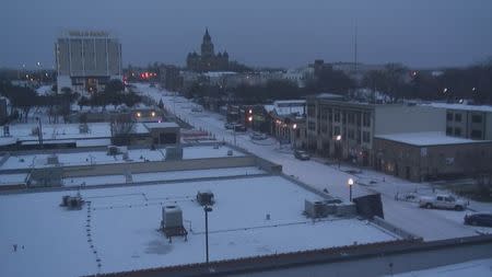 Downtown Denton, Texas is pictured from atop the Central Fire Station in this handout photo taken February 23, 2015, provided by the Denton Police Department. Commuters across the South faced dicey driving conditions on Tuesday as snow and ice blanketed roads, a wintry mix that turned some highways into parking lots and caused schools to close even after buses were already picking up students. REUTERS/Denton Police Department/Handout