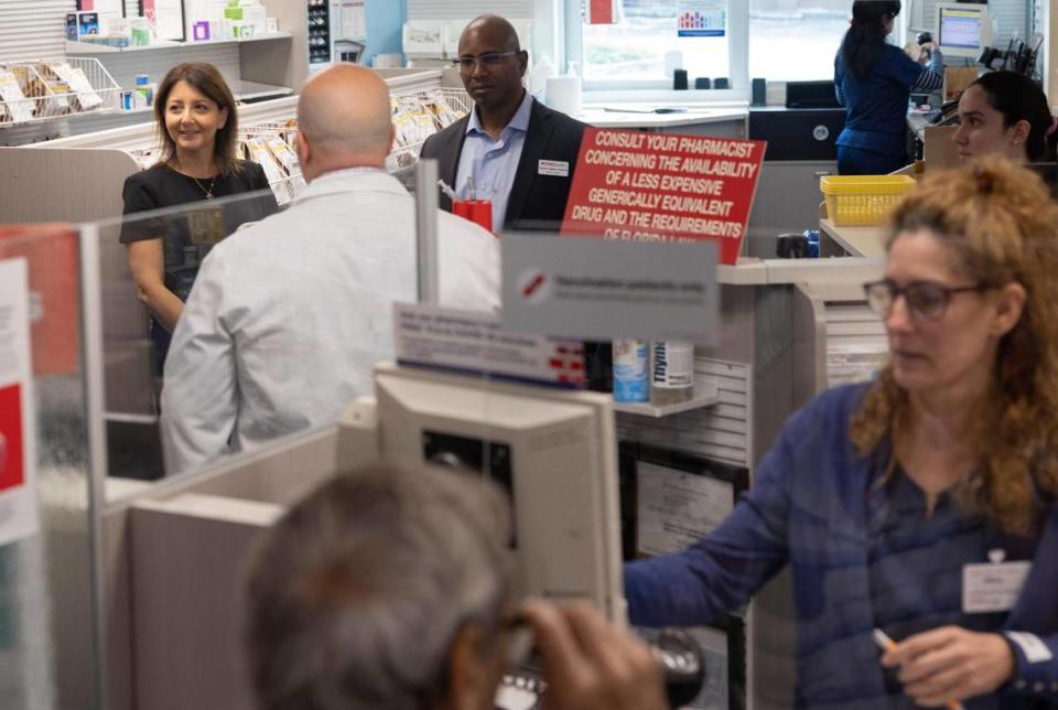 CDC Director Mandy Cohen, back left, talks to pharmacy workers during a visit to CVS Pharmacy on Monday, Oct. 16, 2023, located on SW 40th Street in Miami.