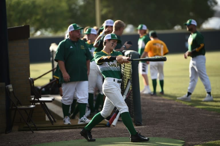 Santa Fe High School baseball team players warm up before a game, just one day after several of their classmates were murdered in a shooting at their Texas school