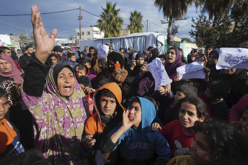 Palestinian protesters demand an end to the war with Israel and call for the release of the Israeli hostages held in the Gaza Strip by the Hamas militant group, in Deir al Balah, Gaza Strip, on Wednesday, Jan. 24, 2024. Israel has said it will not end the war without a release of the more than 100 hostages, while Hamas says it will not free the hostages without a halt in the fighting. (AP Photo/Adel Hana)