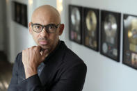 Harvey Mason jr., CEO of The Recording Academy, poses amongst commemorative records he has worked on during his career, at Harvey Mason Media music production studios, Monday, Oct. 11, 2021, in Burbank, Calif. (AP Photo/Chris Pizzello)