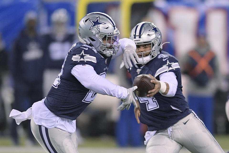 Dallas Cowboys quarterback Dak Prescott (4) hands off the ball to running back Ezekiel Elliott (21) during the first quarter of an NFL football game against the New York Giants, Monday, Nov. 4, 2019, in East Rutherford, N.J. (AP Photo/Bill Kostroun)