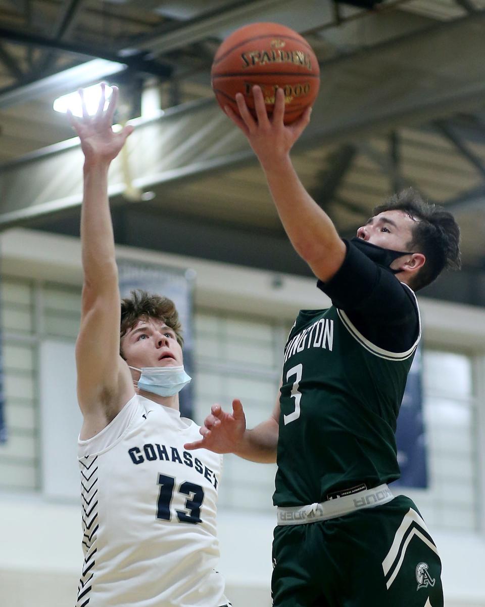 Abington's Tommy Fanara goes up for a shot while being defended by Cohasset's Will Baker during first quarter action of their South Shore League game at Cohasset High on Tuesday, Jan. 4, 2022.