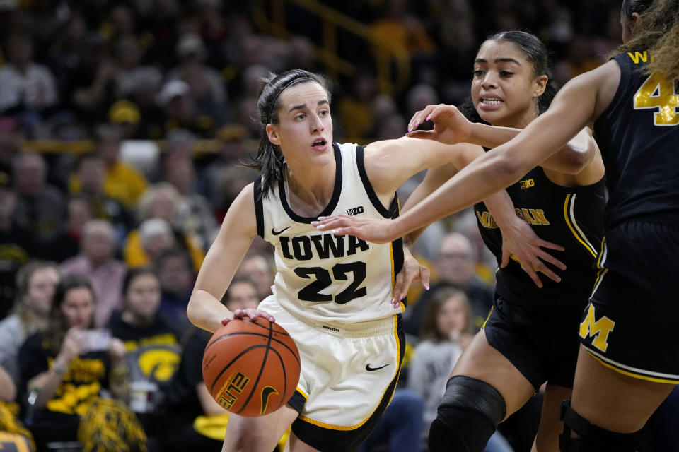 Iowa guard Caitlin Clark (22) drives against Michigan guard Laila Phelia during the second half of an NCAA college basketball game, Thursday, Feb. 15, 2024, in Iowa City, Iowa. (AP Photo/Matthew Putney)