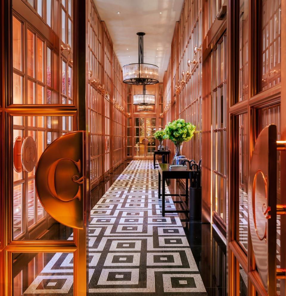 A rose bronze gallery with mozaic flooring takes guests from the airy courtyard to the hotel’s sleek lounge and reception area (Handout)