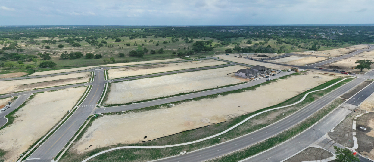 Tri Pointe plans to build 334 homes in three styles at the master-planned Lariat community in Liberty Hill, northwest of Austin. This photo, taken last month, shows Tri Pointe's current inventory on the right side.