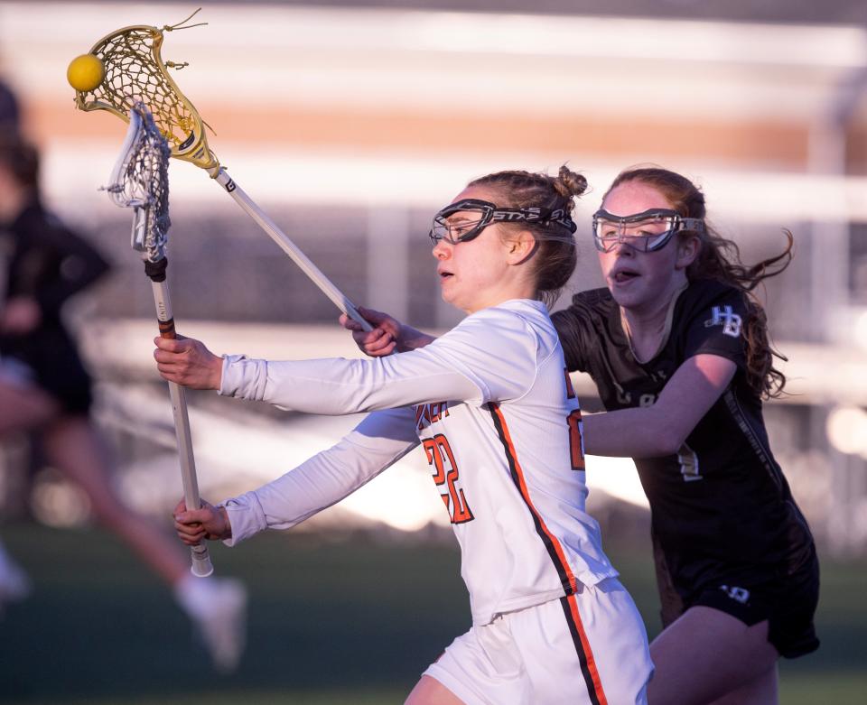Hoover's Lauren West, left, fights for the ball against Hathaway Brown's Faith Farenmouth in the first half at Hoover Thursday, April 25, 2024.