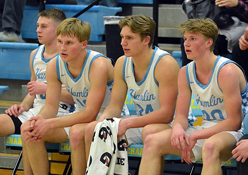 Hamlin players, from left, Easton Neuendorf, Evan Storm, Daswon Noem and Tyson Stevenson watch from the bench during the final minutes of a high school boys basketball game on Monday, Feb. 5, 2024 at the Hamlin Education Center. No. 2 Hamlin topped No. 4 Sioux Valley 80-48 in a battle of rated Class A teams.