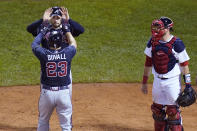 Atlanta Braves' Adam Duvall (23) is congratulated by Travis d'Arnaud, after his second home run of the game during the sixth inning of a baseball game, against the Boston Red Sox, Wednesday Sept. 2, 2020, in Boston. At right is Boston Red Sox catcher Kevin Plawecki. (AP Photo/Charles Krupa)