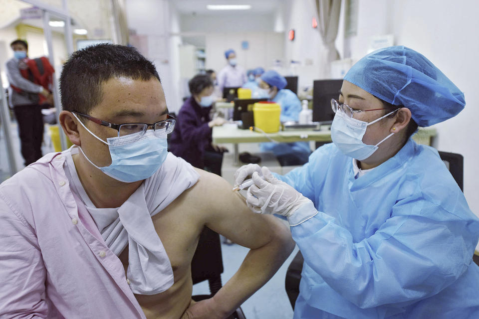 A man wearing a face mask to help curb the spread of the coronavirus receives a shot of Sinovac COVID-19 vaccine at a community health center in Hangzhou in east China's Zhejiang province on Monday, March 15, 2021. Sinovac said its COVID-19 vaccine is safe in children ages 3-17, based on preliminary data, and it has submitted the data to Chinese drug regulators for approval. More than 70 million shots of Sinovac's vaccine have been given worldwide, including in China. (Chinatopix Via AP)