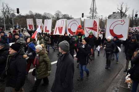 People hold signs of letters composing the word 'Freedom' as they march in an anti-government protest in Warsaw, Poland December 18, 2016. Agencja Gazeta/Franek Mazur/via REUTERS