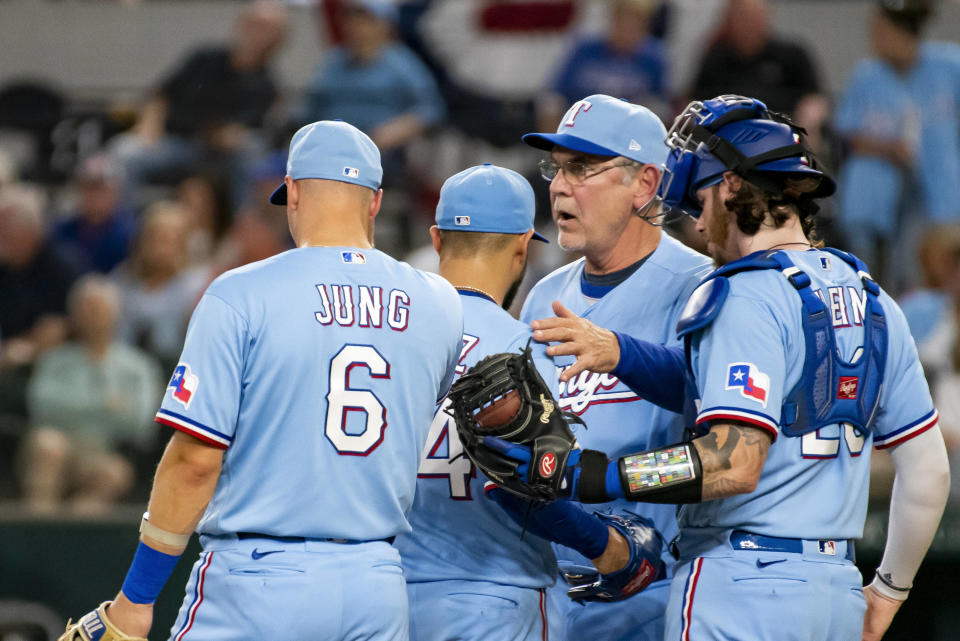 Texas Rangers manager Bruce Bochy, second from right, takes the ball from Texas Rangers starting pitcher Martin Perez, second from left, in the top of the sixth inning in a baseball game against the Philadelphia Phillies in Arlington, Texas, Sunday, April 2, 2023. (AP Photo/Emil T. Lippe)