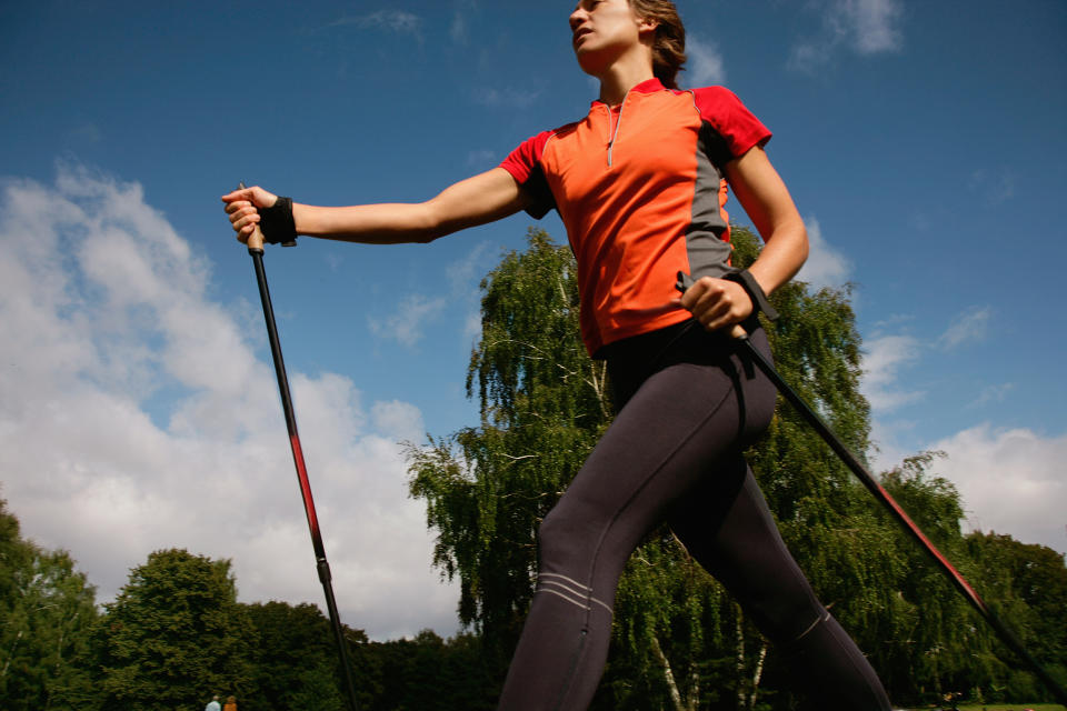 Woman hiking in park (Yashoda / Getty Images)