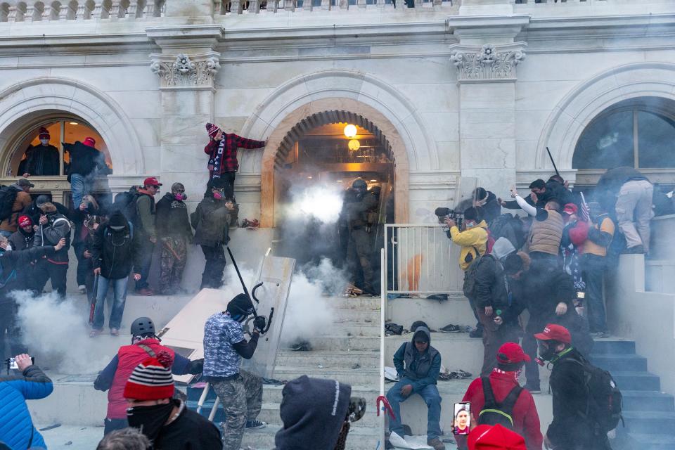 Security forces combat rioters with tear gas at the Capitol, January 6, 2021.