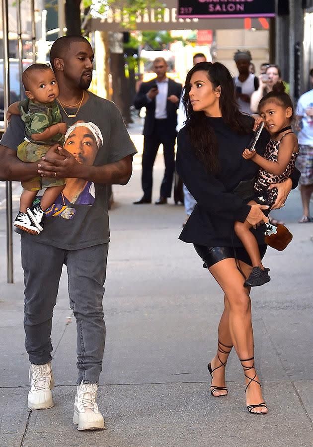 Kim and Kanye carrying their other two children North and Saint. Source: Getty
