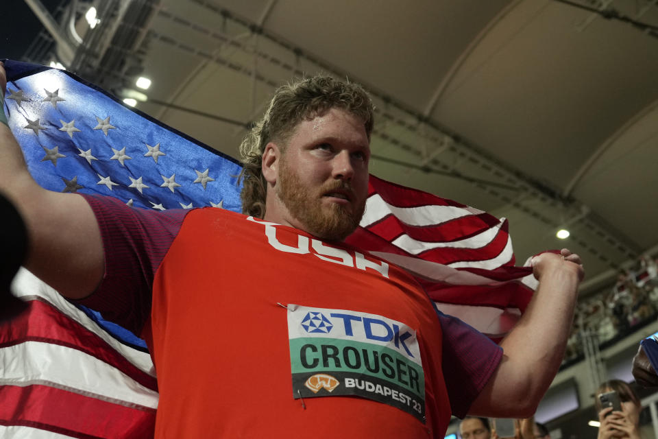 Ryan Crouser, of the United States, celebrates after winning gold in Men's shot put final during the World Athletics Championships in Budapest, Hungary, Saturday, Aug. 19, 2023. (AP Photo/Ashley Landis)