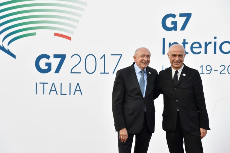 Italy's Interior Minister Marco Minniti (R) welcomes France's Interior Minister Gerard Collomb on October 19, 2017 for the G7 summit of Interior Ministers