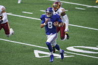 New York Giants' Daniel Jones (8) runs away from Washington Football Team's Landon Collins (26) during the first half of an NFL football game Sunday, Oct. 18, 2020, in East Rutherford, N.J. (AP Photo/John Minchillo)