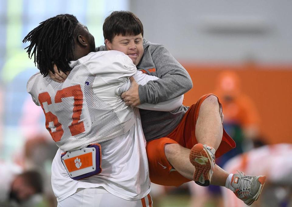 Clemson defensive lineman Albert Huggins (67) hugs equipment manager David Saville during the Tigers Cotton Bowl practice on Friday, December 14, 2018. Clemson Football Practice