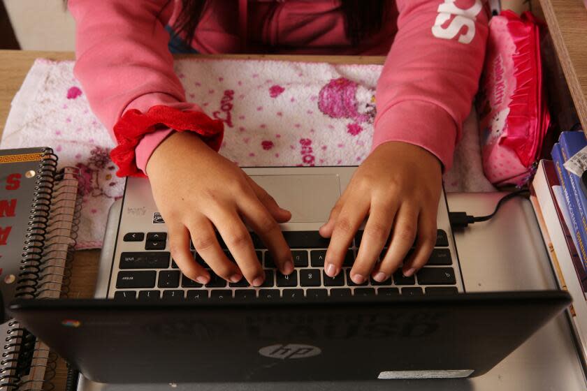 LOS ANGELES, CA - DECEMBER 15: Aida Vega's daughter shows her workspace in Huntington Park on Tuesday, Dec. 15, 2020 in Los Angeles, CA. Vega's daughter is not yet proficient in English and together with distance learning it has been challenging keeping up in school (Dania Maxwell / Los Angeles Times)