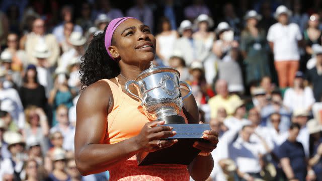 Serena Williams of the U.S. poses with the trophy during the ceremony after defeating Lucie Safarova of the Czech Republic during their women's singles final match to win the French Open tennis tournament at the Roland Garros stadium in Paris, France, June 6, 2015.