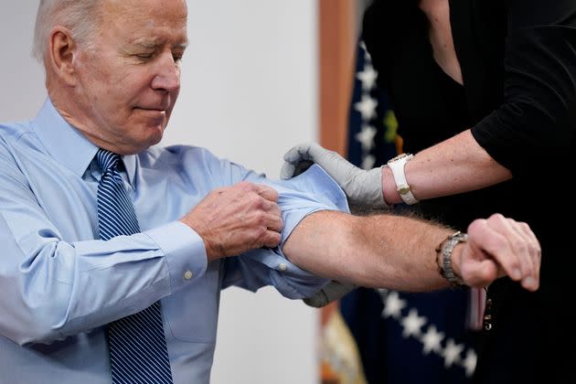 President Joe Biden rolls up his sleeve before receiving his second COVID-19 booster shot on the White House campus on Wednesday. (Photo: AP Photo/Patrick Semansk)